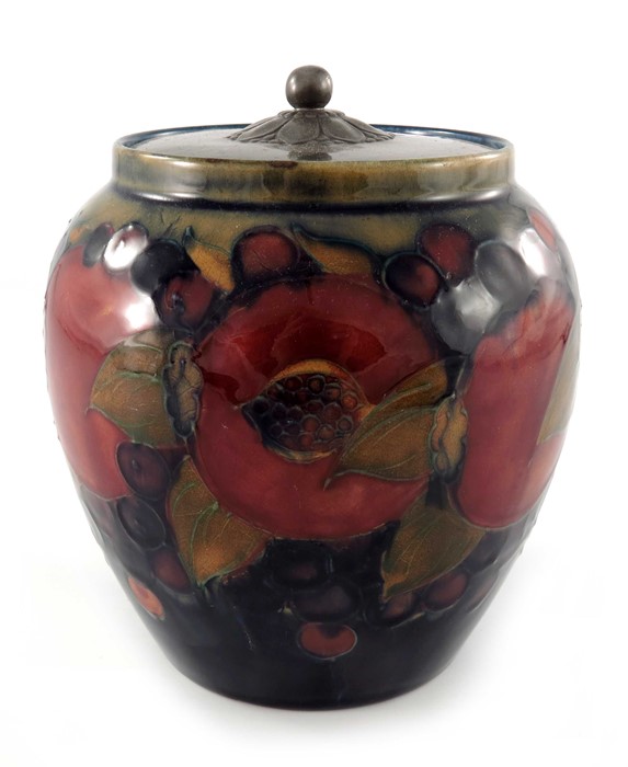 William Moorcroft, a Pomegranate on ochre and blue jar with pewter cover