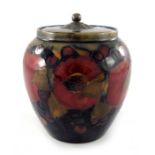 William Moorcroft, a Pomegranate on ochre and blue jar with pewter cover