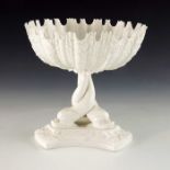 A Royal Worcester blanc de Chine pedestal comport, the relief moulded urchin shell bowl with denticu