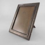 A George V silver photo frame, W I Broadway and Co., Birmingham 1919, rectangular with relief moulde