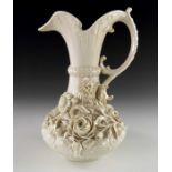 A Belleek florally encrusted jug, second period mark