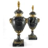 A pair of 20th century French green veined marble urn shaped table lamps, each decorated with rams h