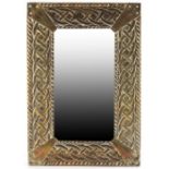 An Arts and Crafts brass mirror