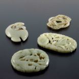 Four Chinese reticulated jade pendants,