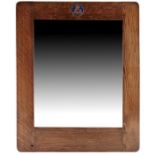 Liberty and Co., an Arts and Crafts oak and enamelled plaque mirror