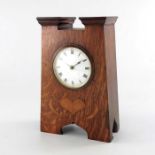 An Arts and Crafts oak and marquetry clock