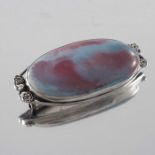An Arts and Crafts silver mounted Ruskin cabochon brooch