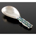 Archibald Knox for Liberty and Co., an Arts and Crafts silver and enamelled caddy spoon, Birmingham