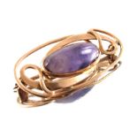 Archibald Knox for Liberty and Co., an Arts and Crafts amethyst and gold brooch
