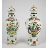 A pair of Chinese famille vert baluster vases and covers