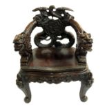 An Oriental carved hardwood armchair