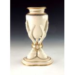 A Royal Worcester relief moulded vase, 1867, modelled as an amphora supported on three birds feet en