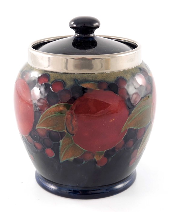 William Moorcroft, a Pomegranate on ochre and blue jar and cover