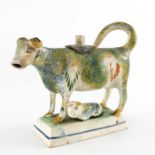 A Staffordshire Prattware sponge decorated cow creamer