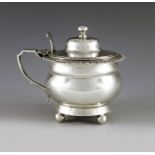 Charles Stuart Harris, London 1902, an Edwardian silver mustard pot, double ogee ovoid form, on four