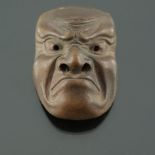 A Japanese Bizen pottery miniature mask, 20th Century, modelled as a disgruntled gentleman,