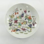 A Chinese circular porcelain dish, 19th Century, painted in polychrome with seventeen boys at