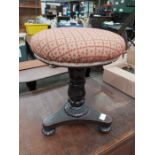 A 19th century rosewood adjustable piano stool on platform base, 44cm high