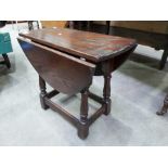 A dark oak drop leaf coffee table, 56cm long