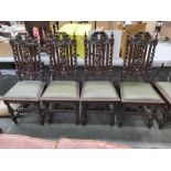 A set of eight Flemish profusely carved high back dining chairs, with green fabric seats (8)