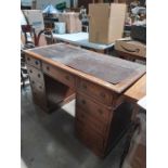 A late 19th century inlaid pine and oak twin pedestal desk, fitted nine drawers, 122cm wide