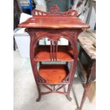 An Art Nouveau design three tier mahogany table, 45cm wide