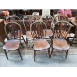 A Harlequin set of seven wheel and draft back elm and fruitwood Windsor chairs, comprising elbow and