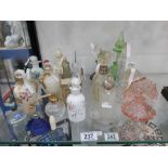 A collection of scent and perfume bottles, some silver mounted 20+