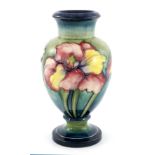 Walter Moorcroft, an Orchid pedestal vase, inverse baluster form, painted and tubelined decoration