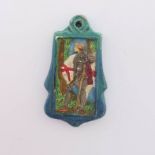 A Compton Pottery pendant, of cartouche form, depicting St George in relief, polychrome decorated
