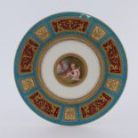 A Minton cabinet plate, painted with a central roundel of a cherub, raised gilt and jewelled border,