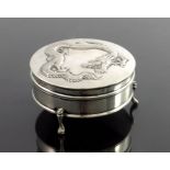 A Chinese silver three-footed box, with dragon motif