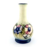 William Moorcroft, an Anemone vase, circa 1930, bottle form, pink and violet on a cream ground,