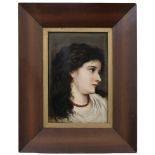 A late 19th Century porcelain portrait plaque of a young European lady in profile, wearing a bead