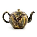 A Staffordshire teapot of Whieldon type, circa 1765, of ovoid form with flower head finial and