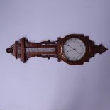 A late Victorian aneroid barometer, circa 1890, carved oak case with scrollwork, thermometer over