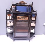 An Aesthetic Movement ebonised and gilt pier cabinet, circa 1880, raised mirror back with shelf