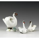 Three Meissen models of swans, 20th Century, all with realistic plumage, the large model on a