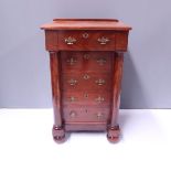 A late 19th Century flame mahogany wellington chest, circa 1870, of Empire design, overhanging