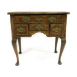 A George II walnut lowboy of small proportions, circa 1740, quarter veneered, strung and crossbanded