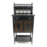 An Aesthetic Movement ebonised music cabinet, circa 1880, raised shelf back with fretwork and