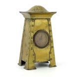 A brass Arts & Crafts timepiece, circa 1900, hammered finish throughout, domed cover, the main