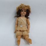 A Kammer & Reinhardt porcelain headed doll, brown sleeping eyes, painted brows and lashes, open