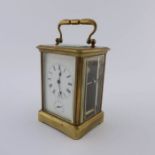 A French carriage alarm clock, late 19th Century, brass corniche case with oval visible escapement