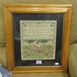 A woolwork sampler, The Sundial, in a birds eye maple cushion frame, 29cm x 25cm