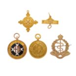 A selection of gold service medals and a brooch