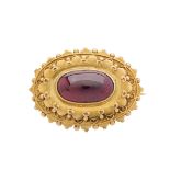 An early 20th century 15ct gold garnet cabochon brooch