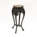 A 19th Century Chinese hardwood stand, inset veined pink marble top, prunus blossom carved base,