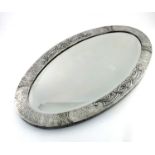 An Arts and Crafts pewter mirror