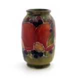 William Moorcroft, a miniature Pomegranate on ochre vase